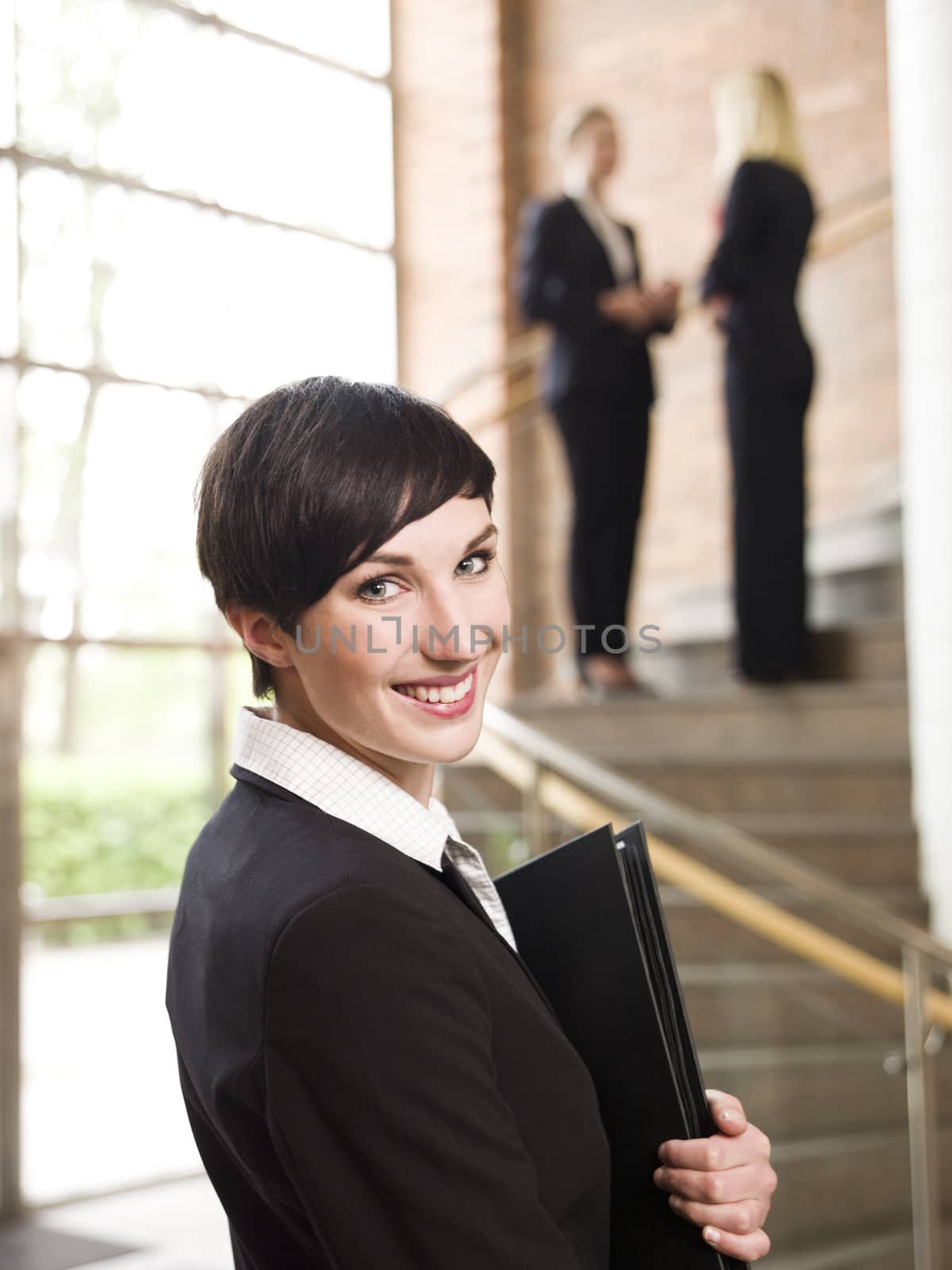 Smiling businesswoman with a folder