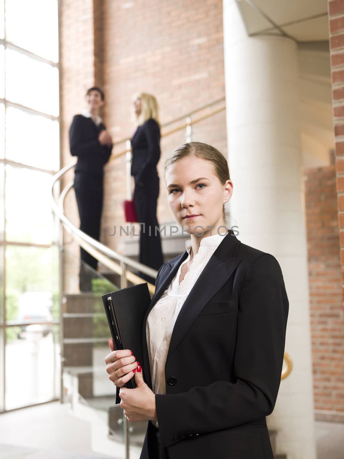 Businesswoman in front of two other women by gemenacom
