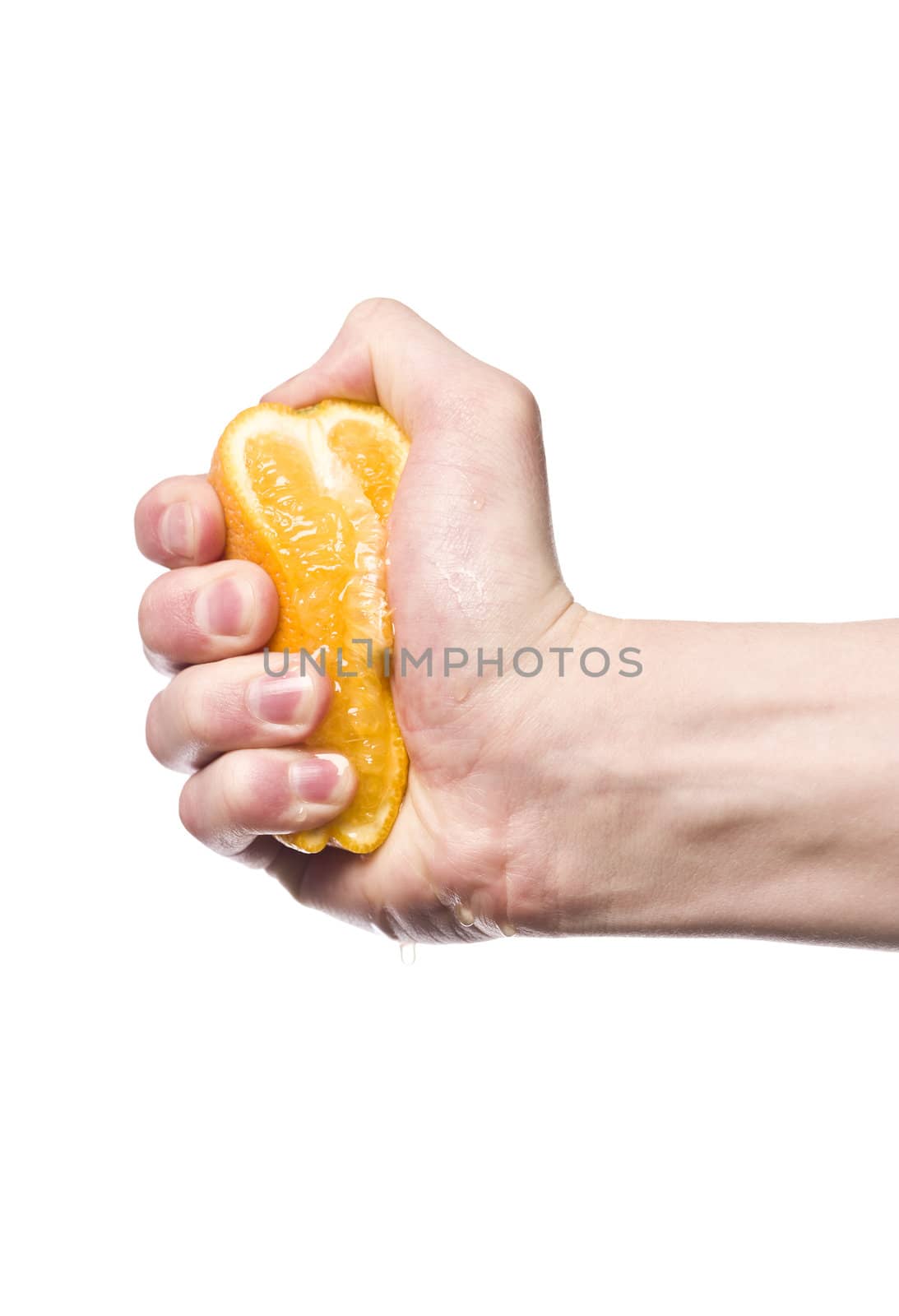 Hand squeezing an orange towards white background