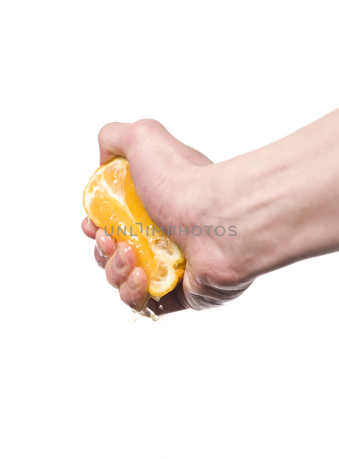 Hand squeezing an orange towards white background