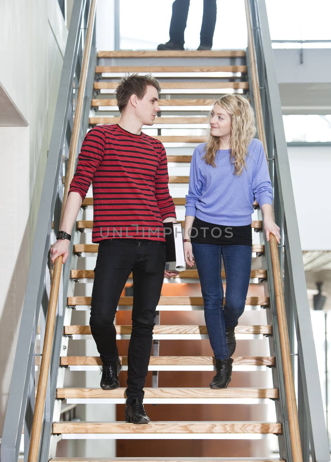 Man and a womanwalk the stairs