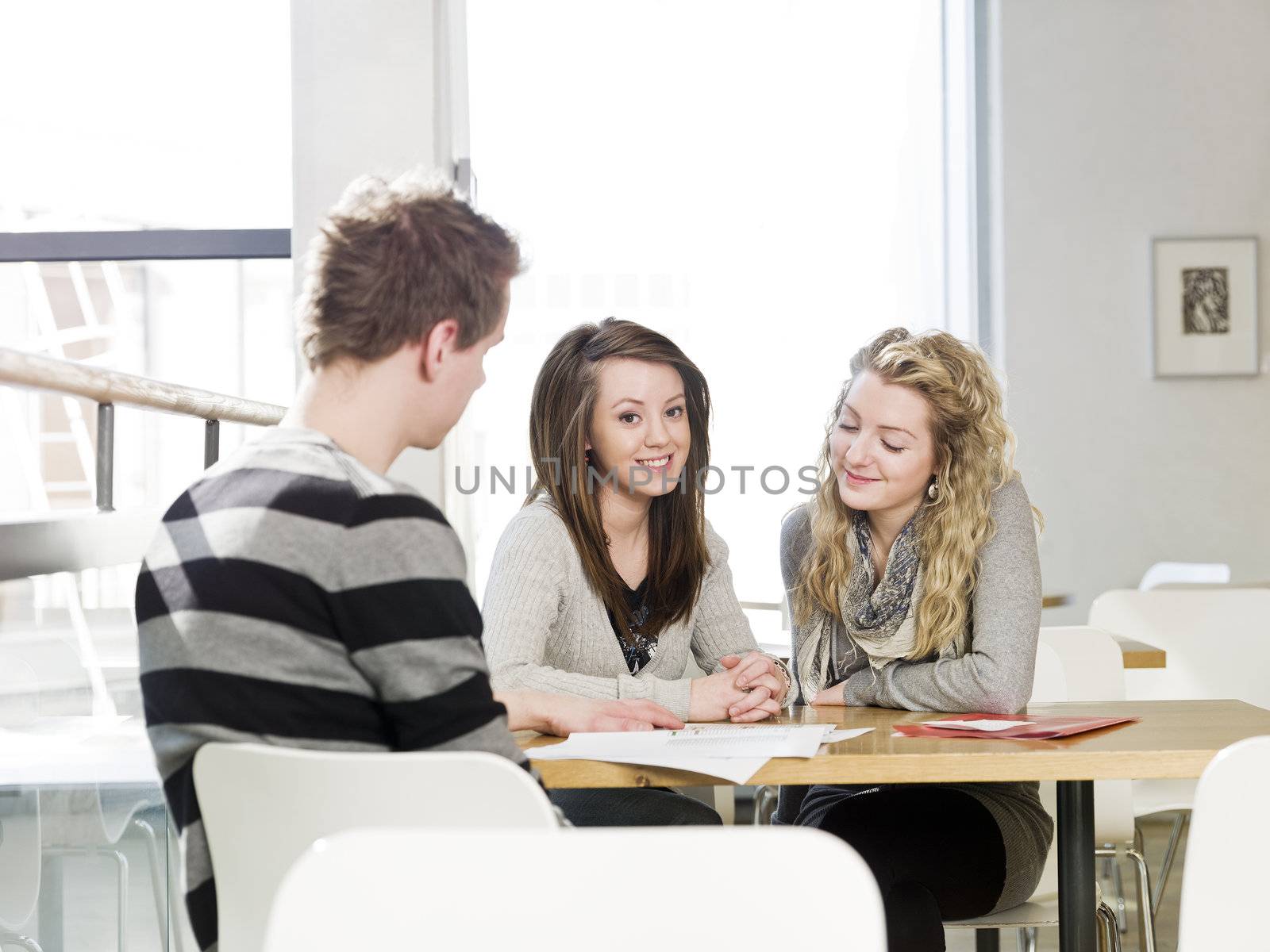 two girls and a man talking