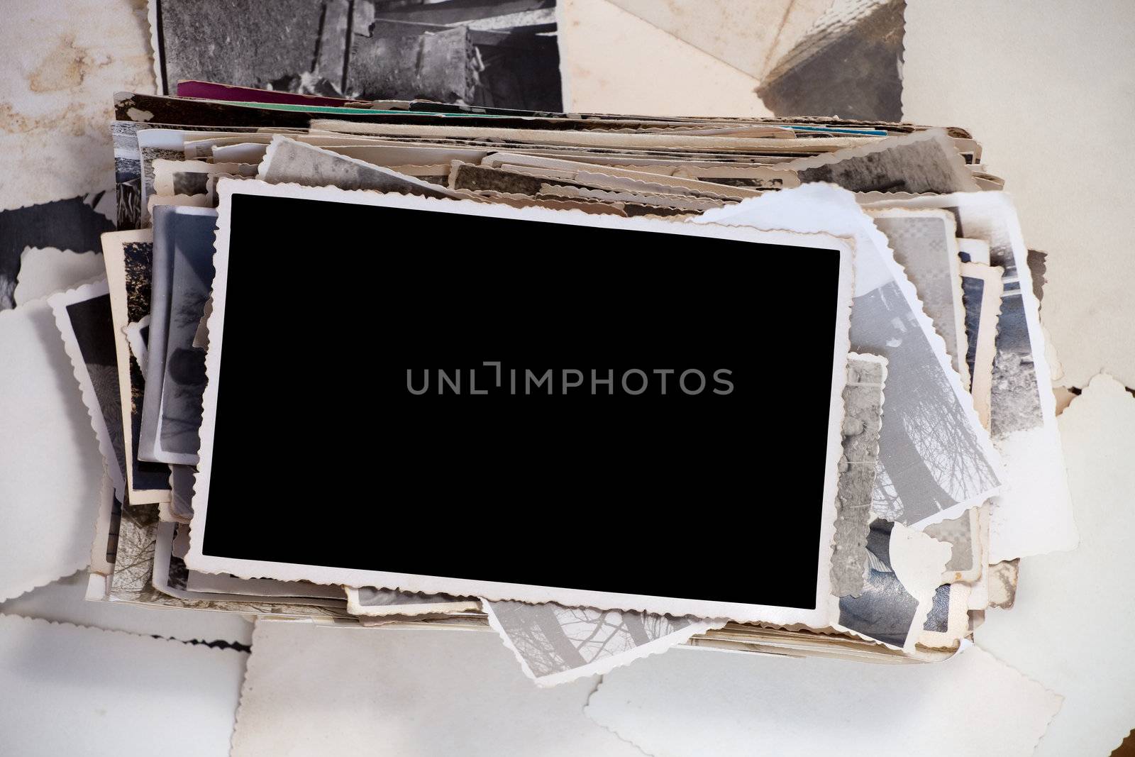 Stack of old photos with one blank photo for your image.