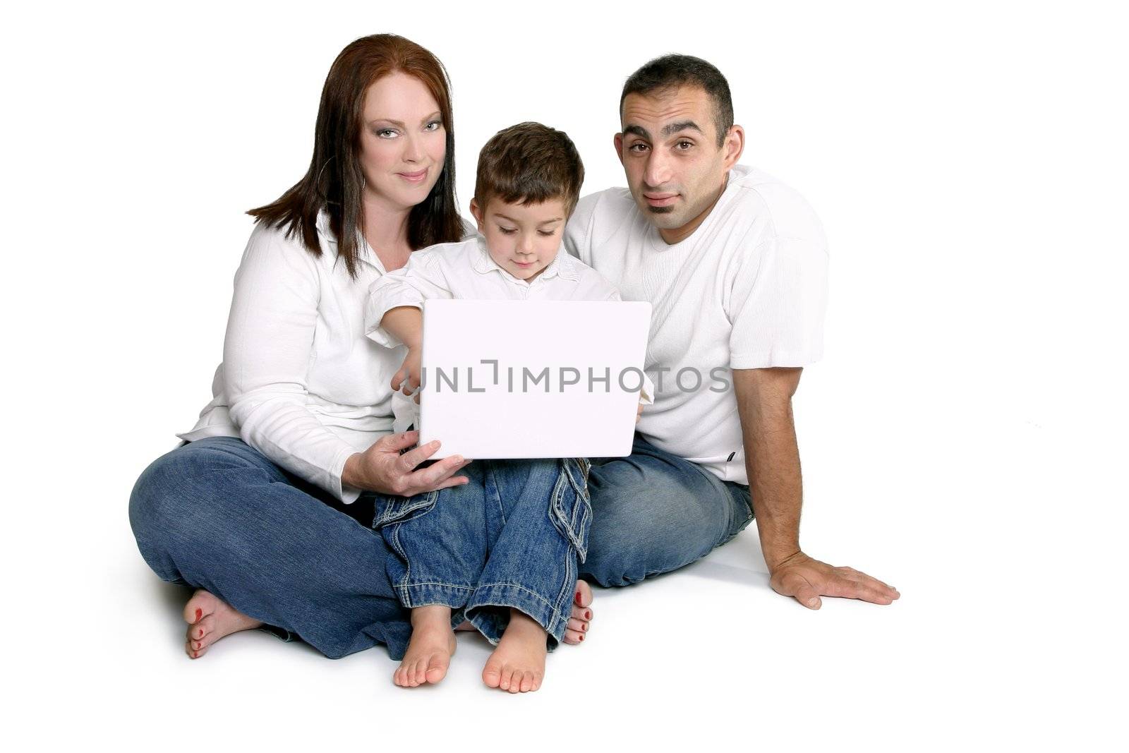 Parents spend time with small child on computer laptop.