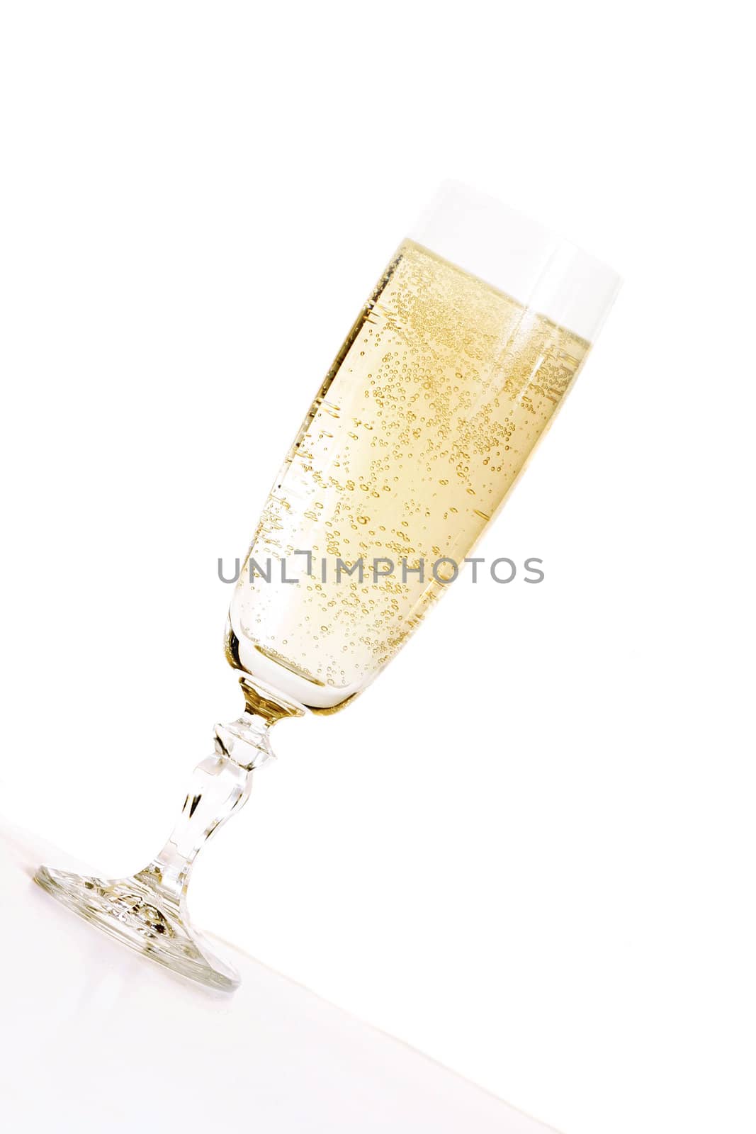 Celebration.  An angled glass of champagne in a champagne flute glass.