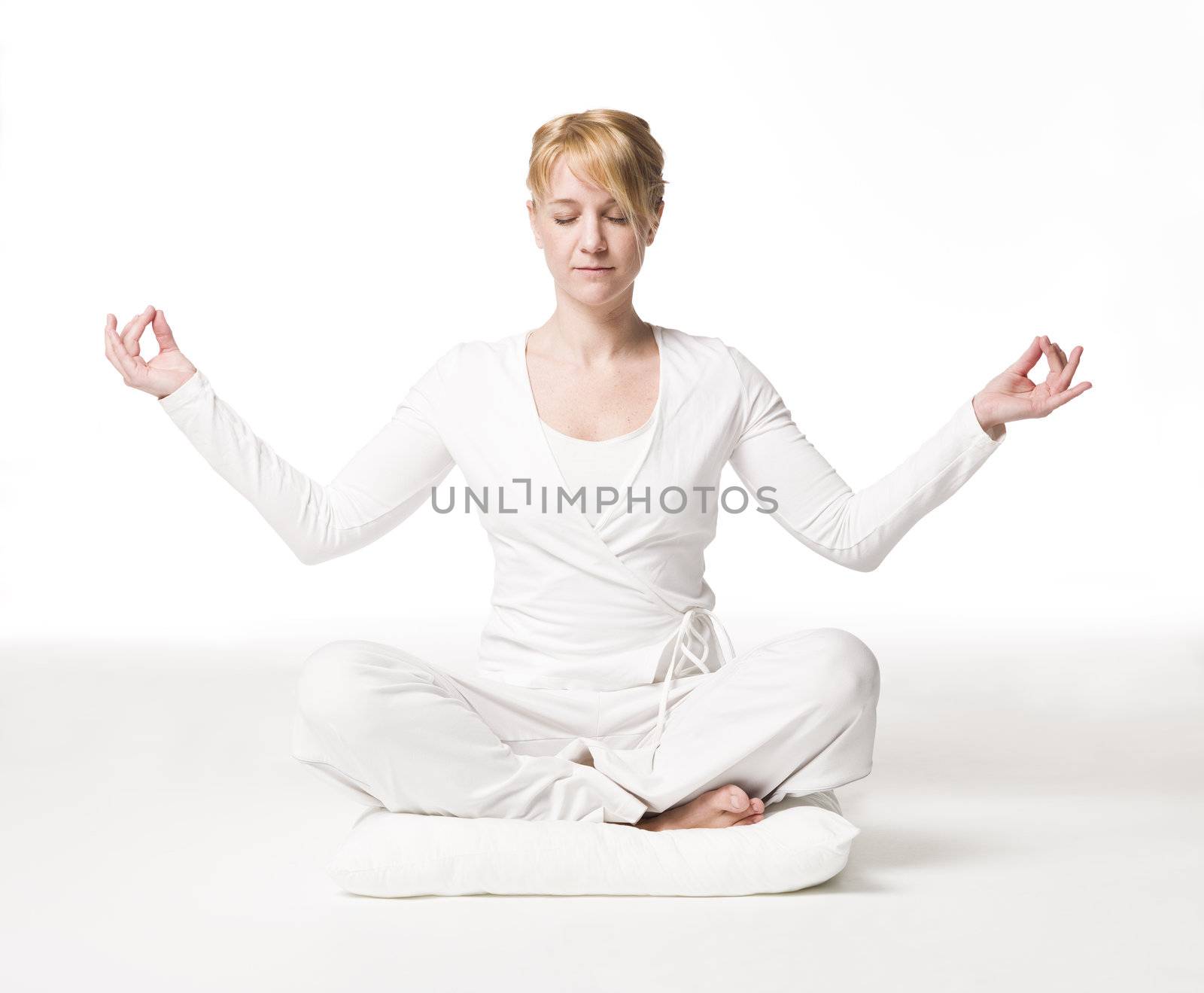 Woman meditating by gemenacom