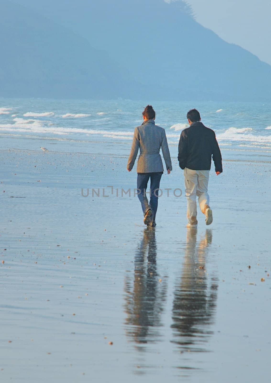 A couple walking on a beach 