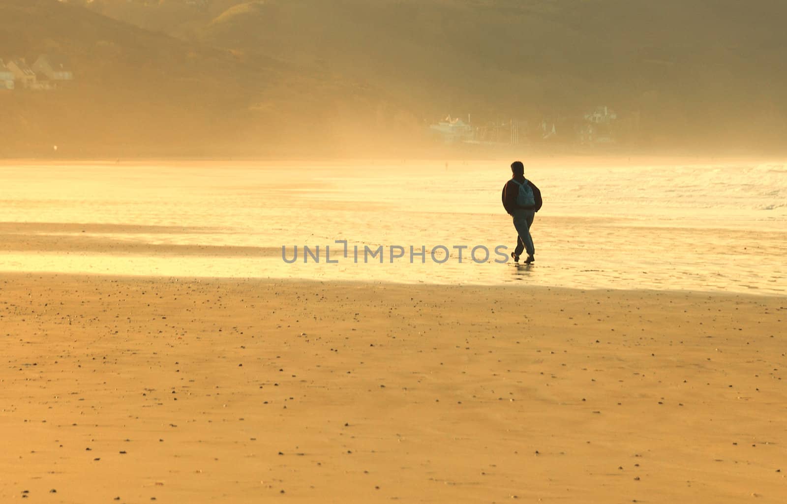 A man walking alone on a beach