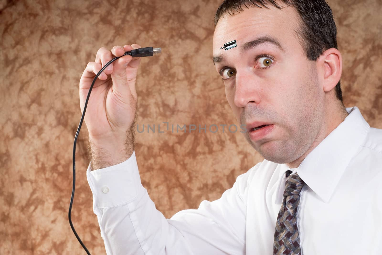 A man about to plug a USB cable into his forhead to transfer data