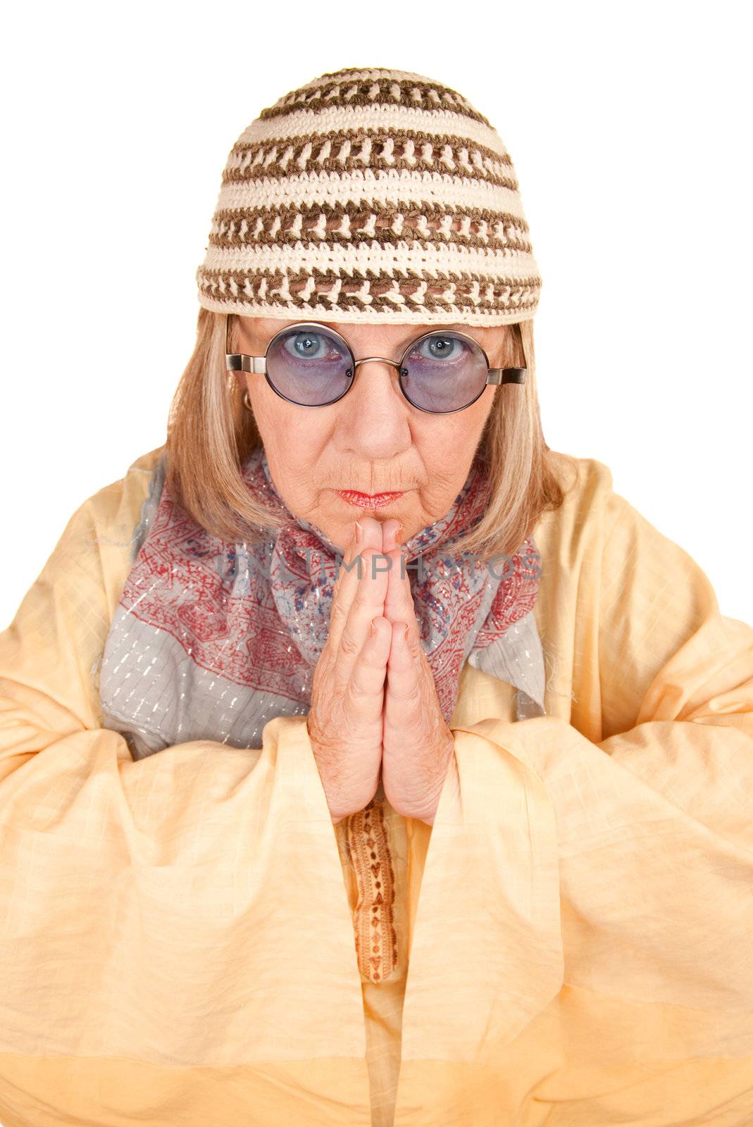 Crazy new age woman with hands together in a yellow robe
