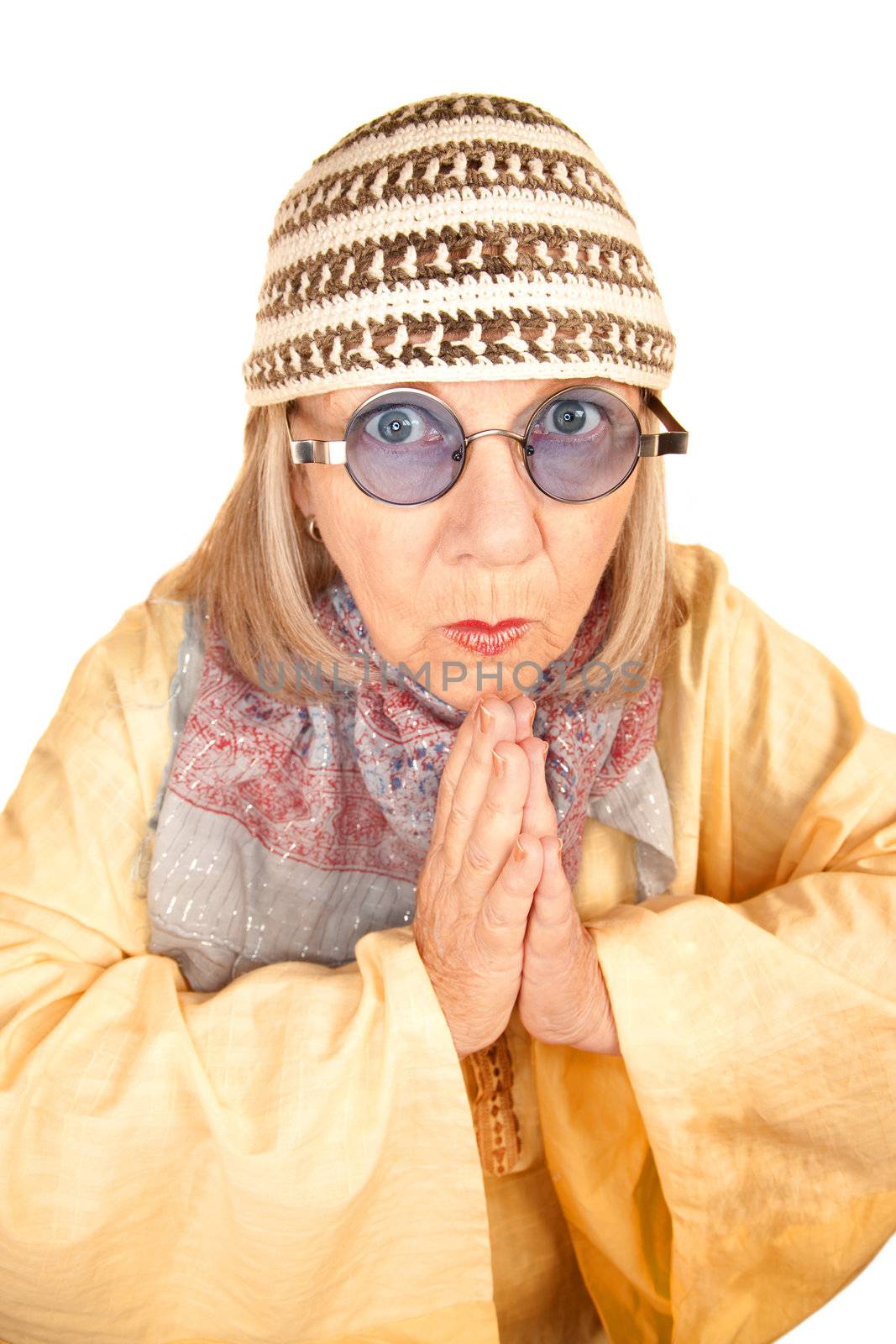 Crazy new age woman with hands together in a yellow robe