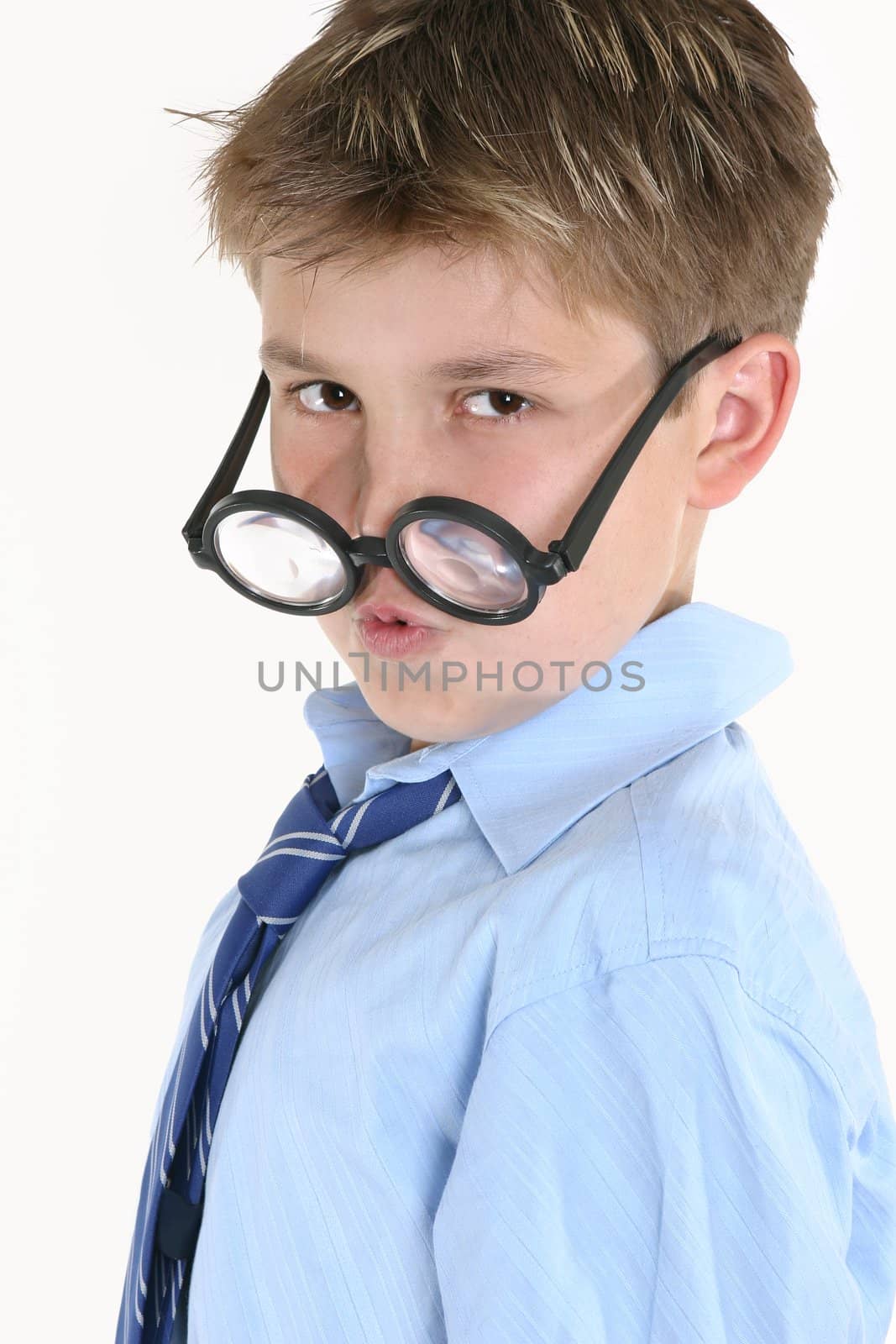 Child looking over the top of round glasses.