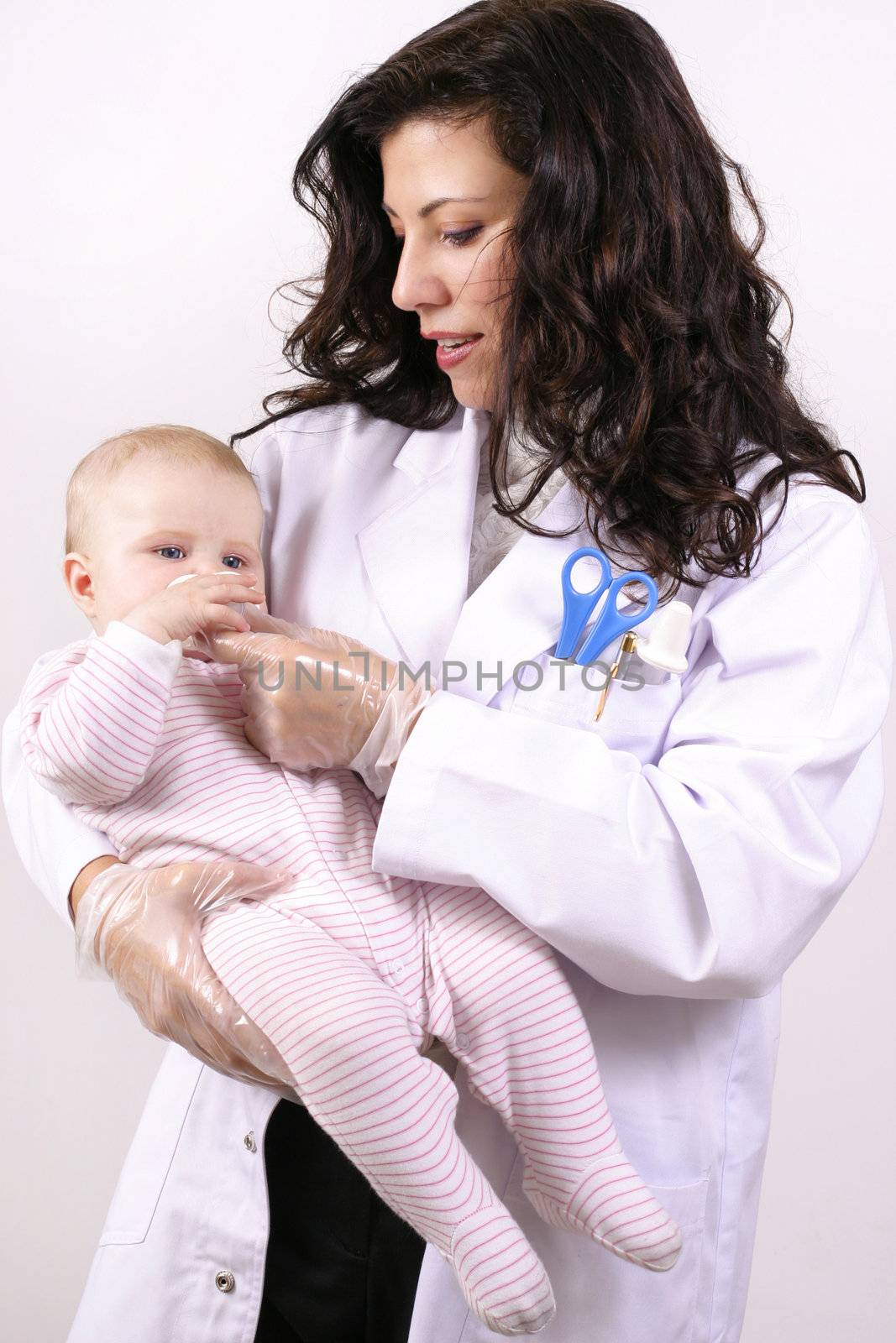 A doctor medicating a baby using a medicator.