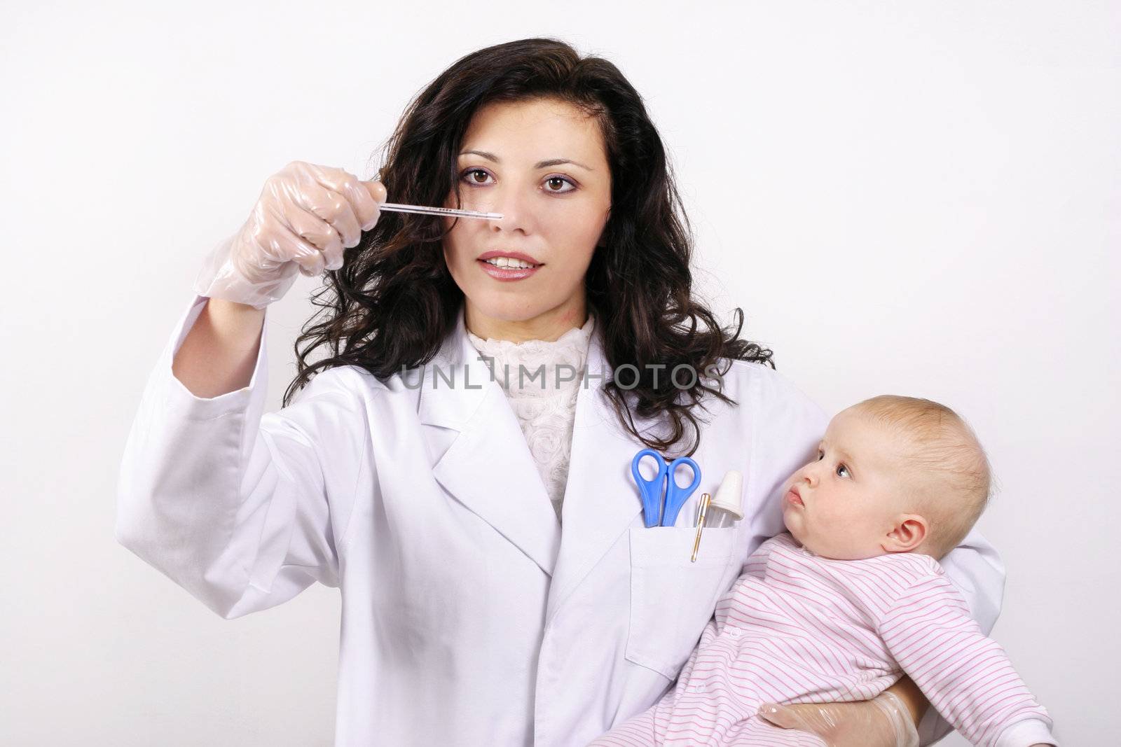 Doctor or nurse with a baby and reading thermometer