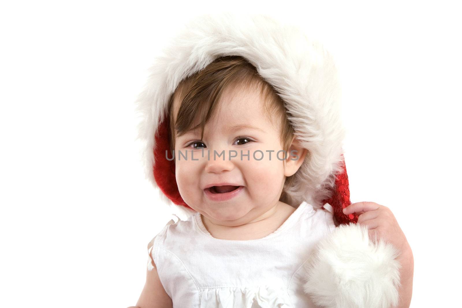 Cute young baby girl with santa hat and laughing