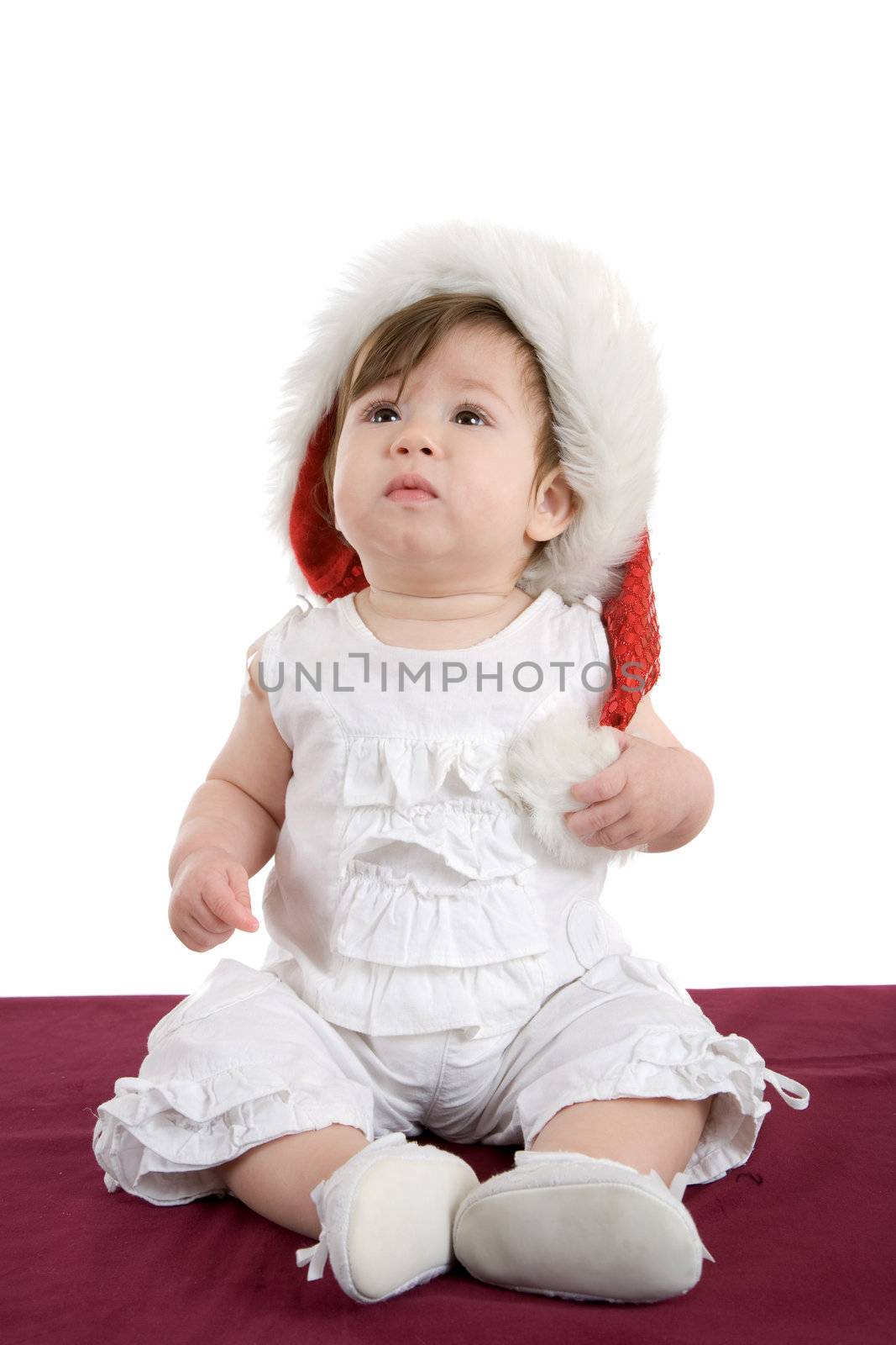 Cute little baby girl sitting on white background