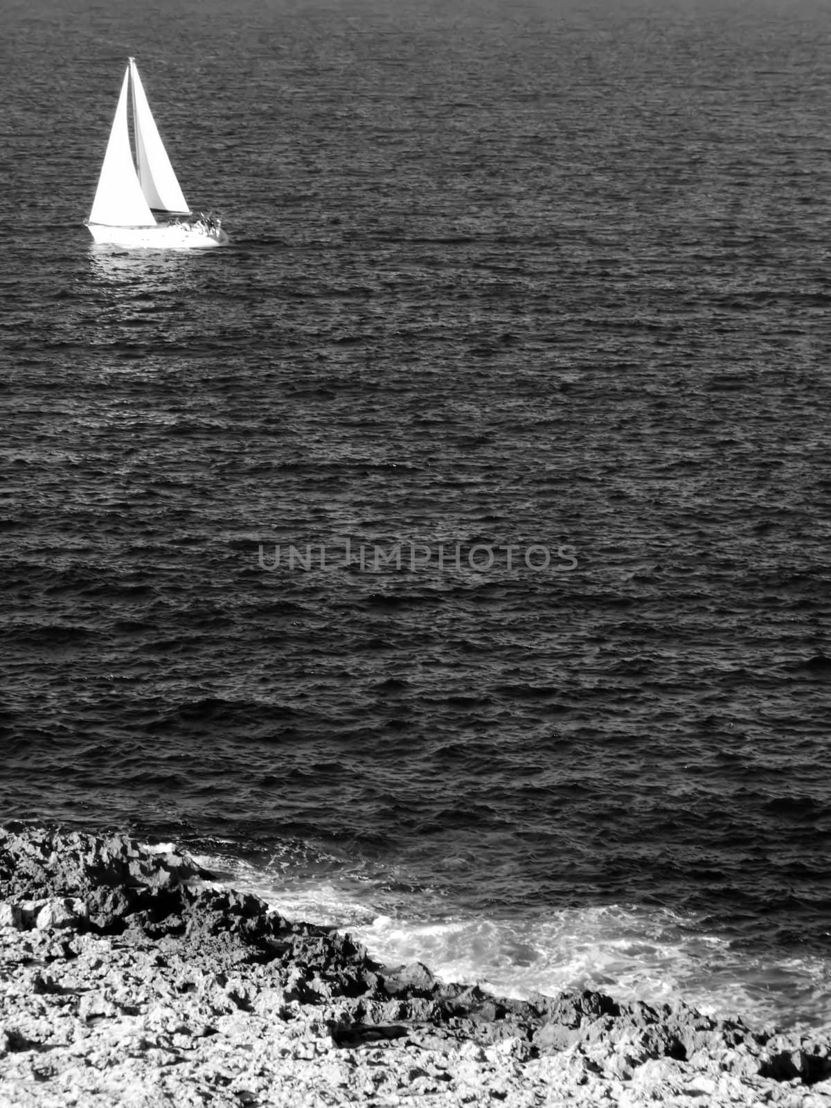 Yacht or sailing boat on calm ocean waters off the Mediterranean coast