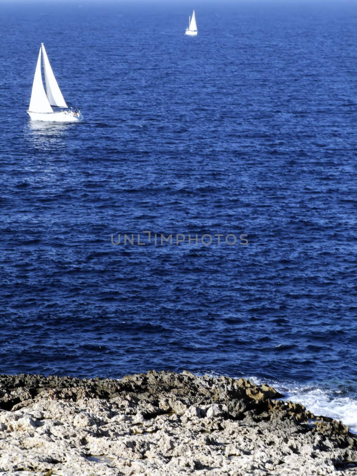 Yacht or sailing boat on calm ocean waters off the Mediterranean coast