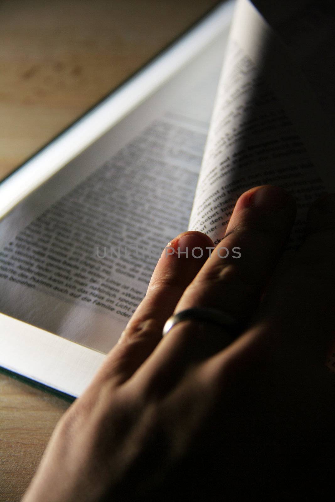 opened pages of a book on wooden table