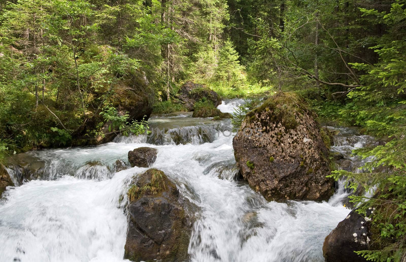 beautiful nature scene with river and waterfall at summer in val di Fassa, italian Dolomites