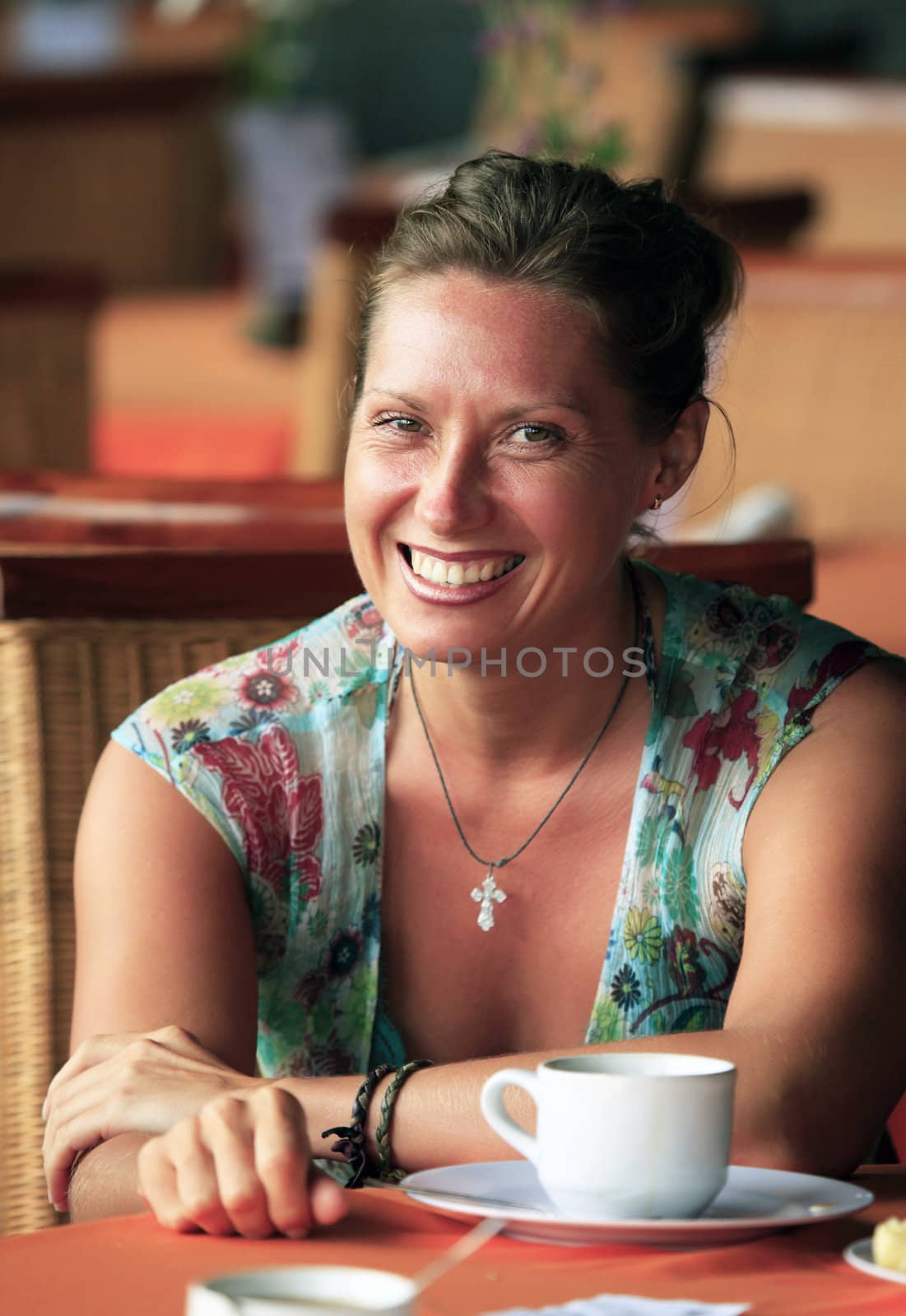 Woman at cafe drinking coffee.