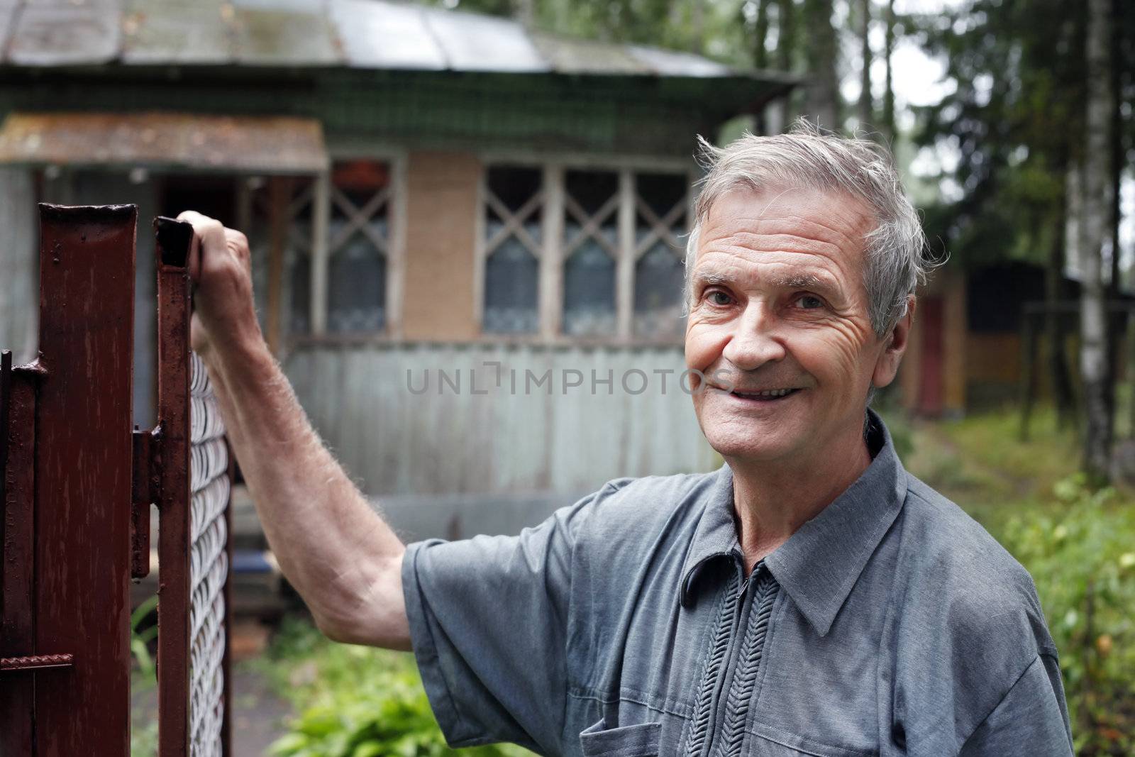 Senior man on a background of an old house