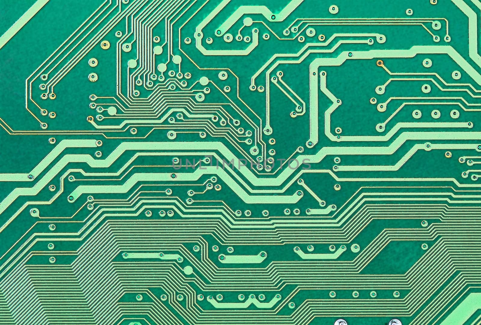 Texture of an electronic plate of green color with metallic paths