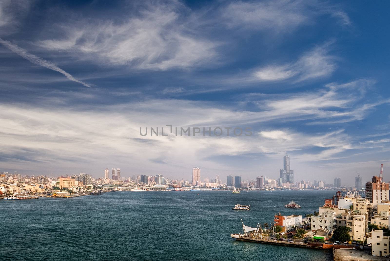 Harbor of modern city with famous skyscraper and boats in Kaohsiung, Taiwan.