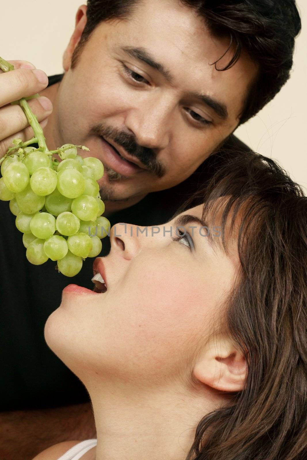 Playfully offers her grapes