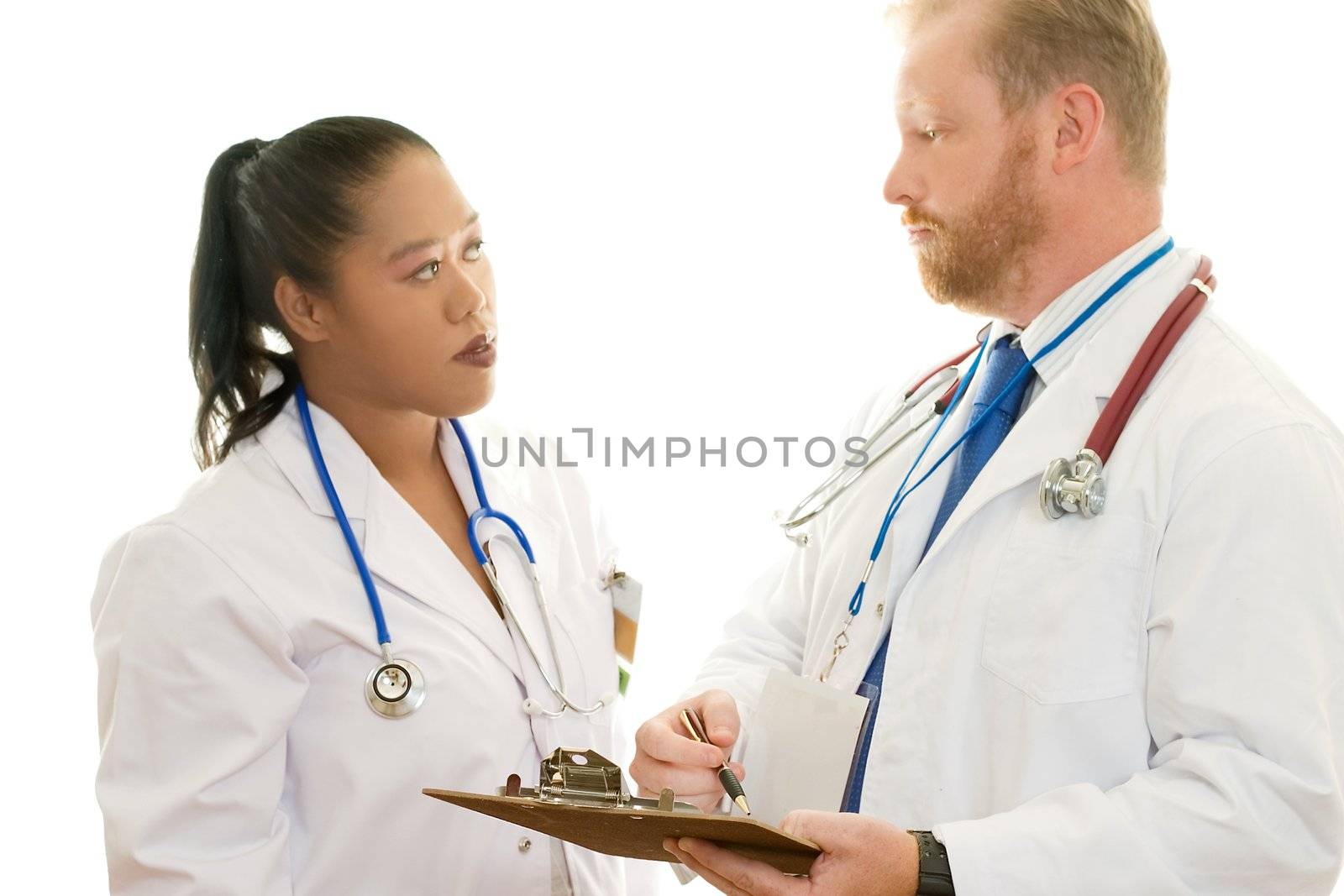 A male and female doctor in discussion.  Focus on man