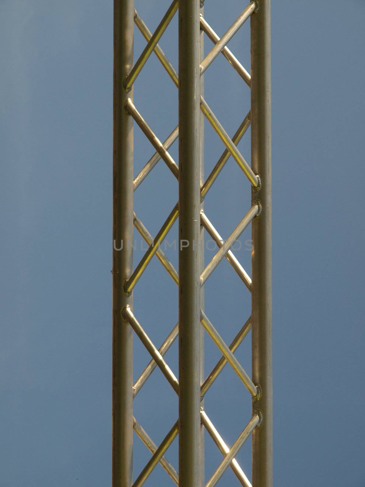 Steel truss beam structure over blue sky background