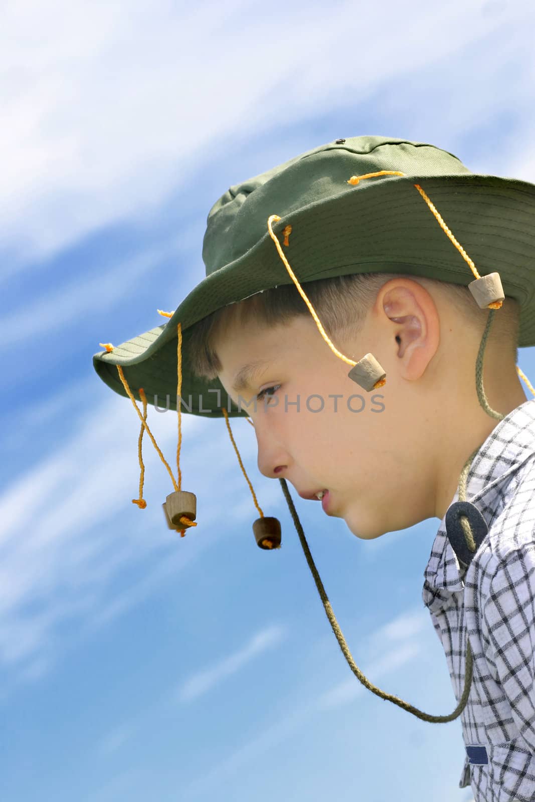 No fllies on me mate! Outback aussie boy wearing a cork hat - against vivid blue sky