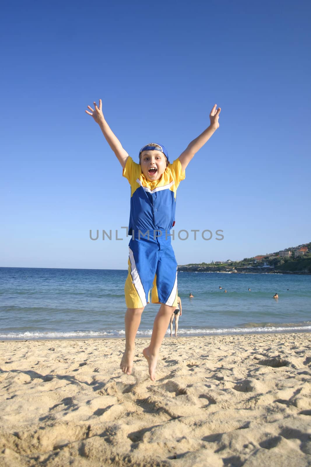 Woo Yah! Child leaps into the air on the beach -- very late autumn afternoon. 