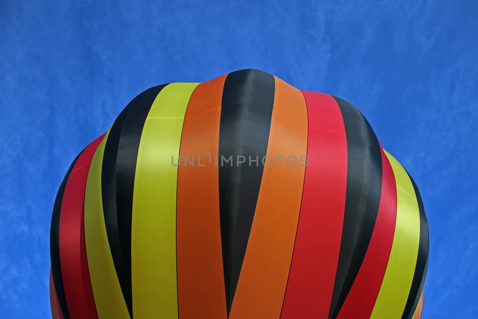 Hot air balloon on blue background with red black and yellow highlights.