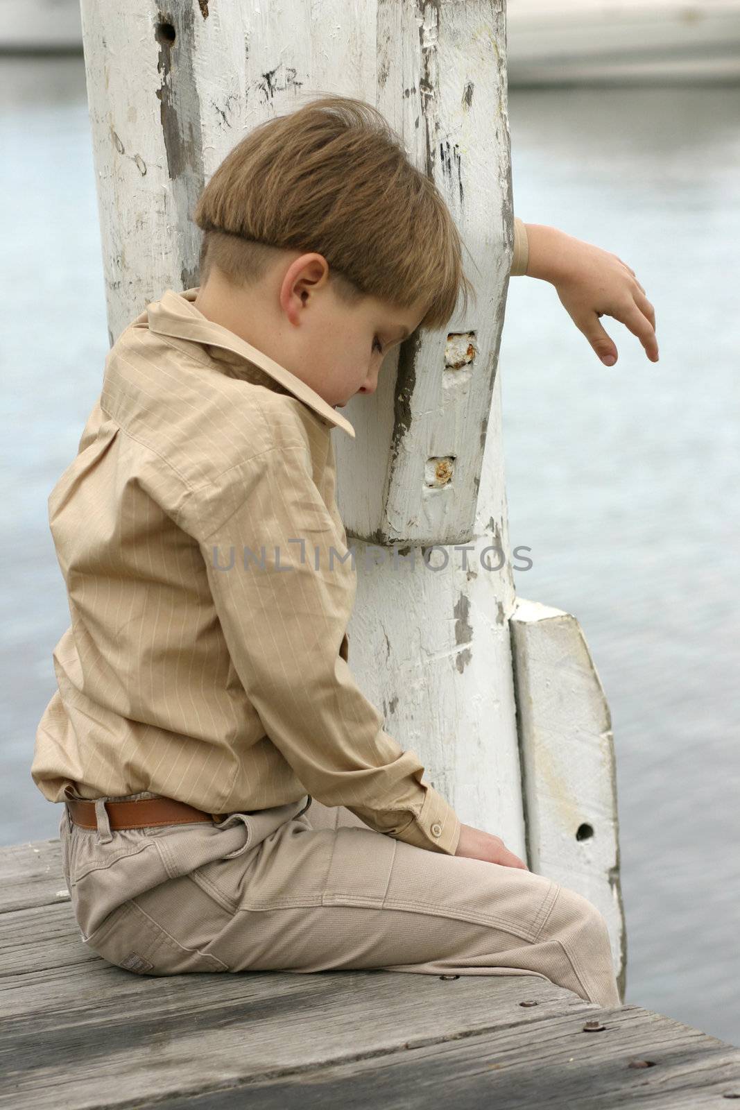 Grieving the loss of a loved one, dog/cat, etc.
Boy hangs head low grieving or lonely