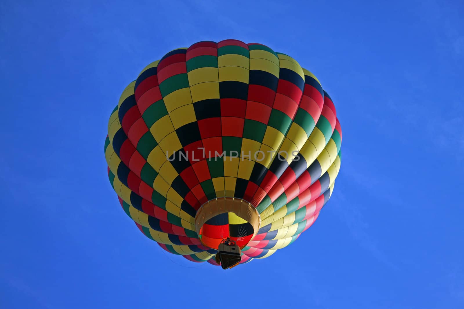 Hot air balloon on blue background with red black and yellow highlights.