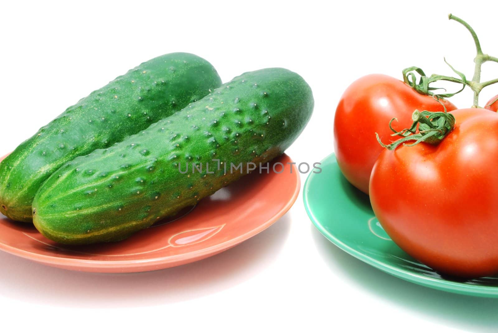 Red Tomatoes  and Two Cucumbers on Plate