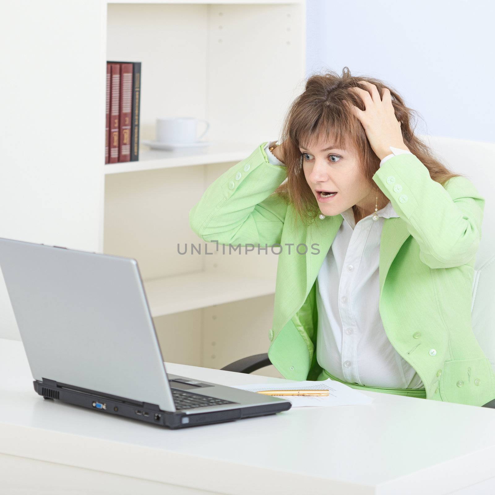 The person in a shock working in the Internet with the laptop