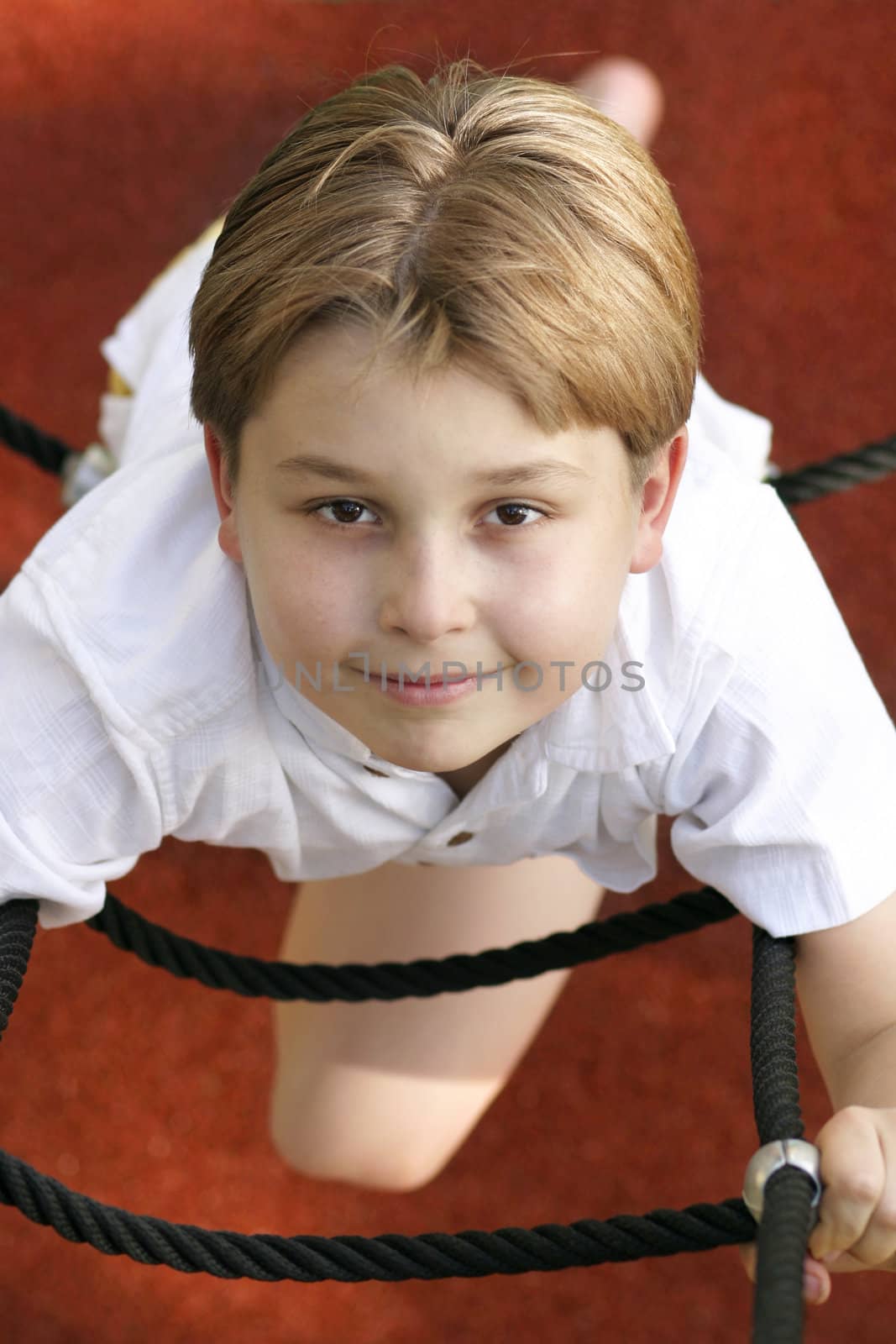 Boy climbs a ladder (above view) .

