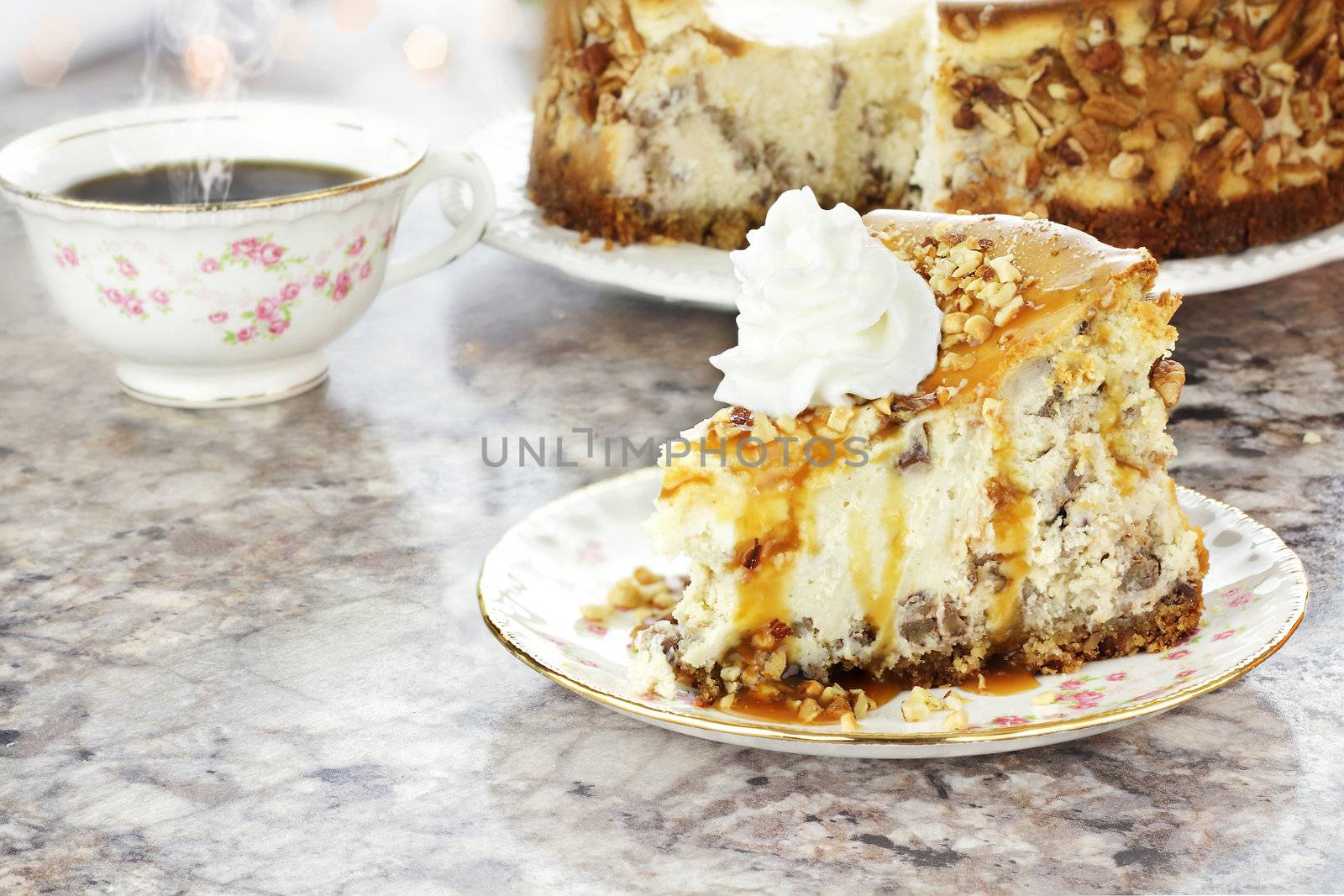 Slice of Southern Pecan Cheesecake with hot coffee in background. Extreme shallow depth of field with selective focus on slice of pie in foreground. Reflection can be seen on granite surface.