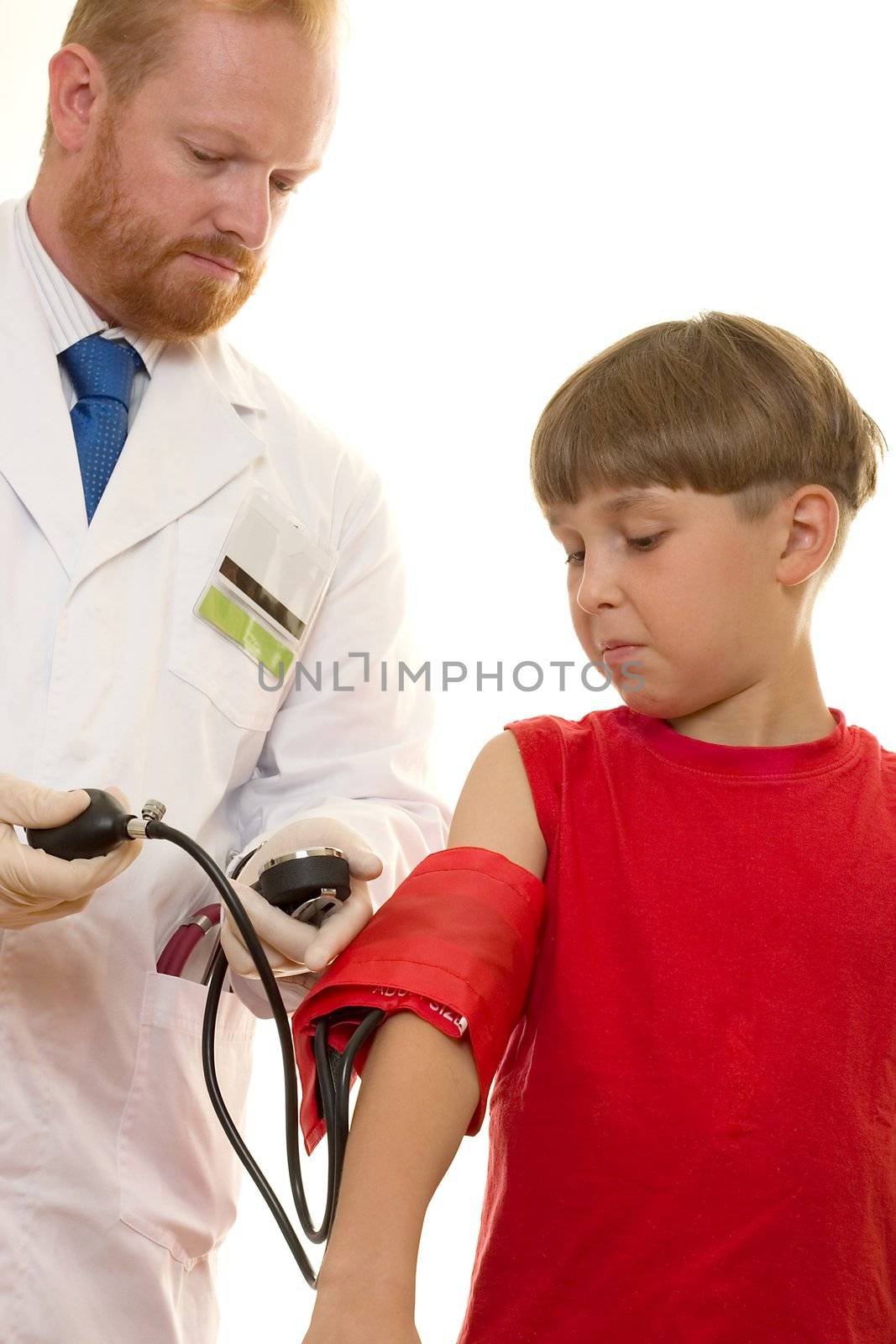 Doctor taking a young patient's blood pressure