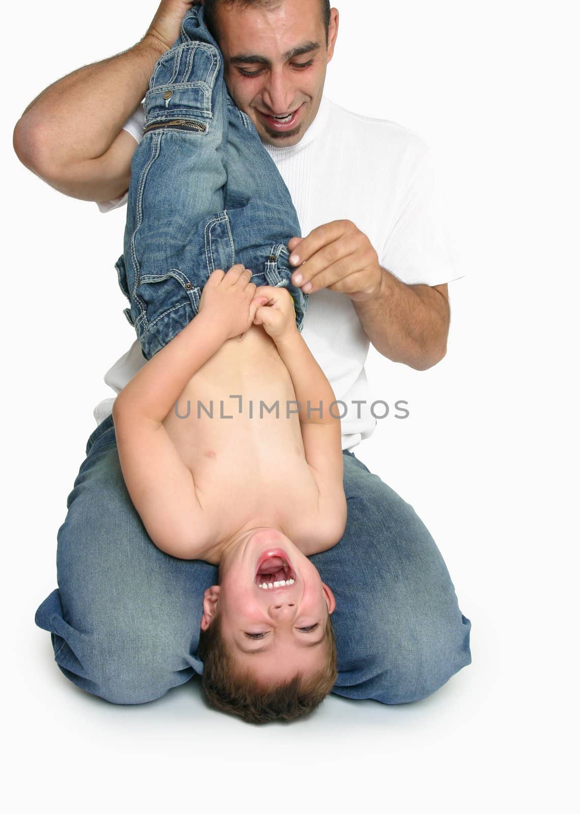 A child laughs gregariously playing with Dad