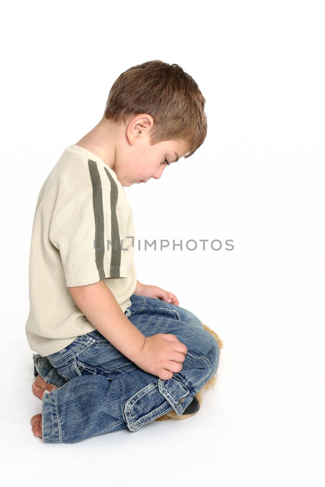 A toddler bows his head in shame.