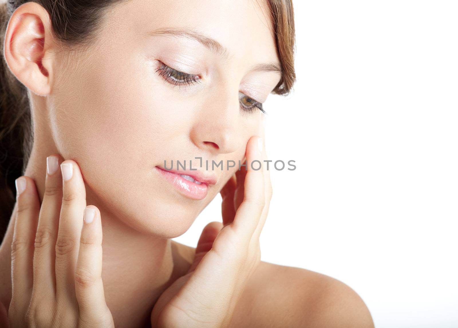 Beautiful young woman taking care of her skin face
