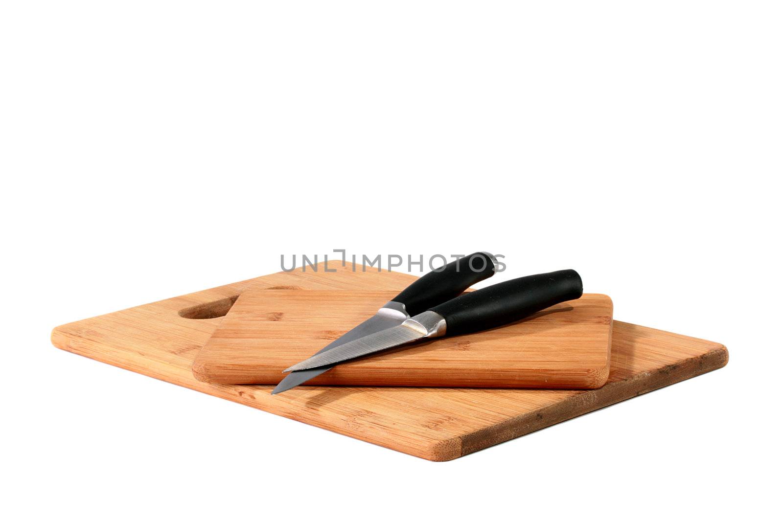 Set from two knifes on bamboo boards for food cutting.