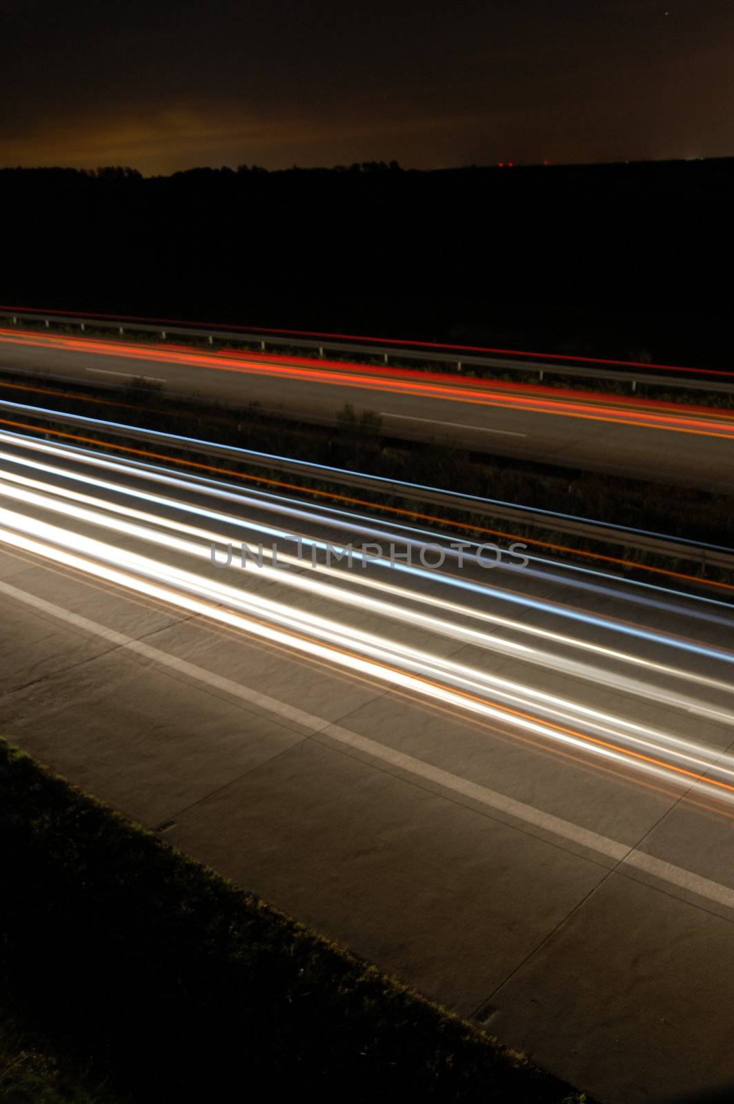 highway at night with car traffic and lights