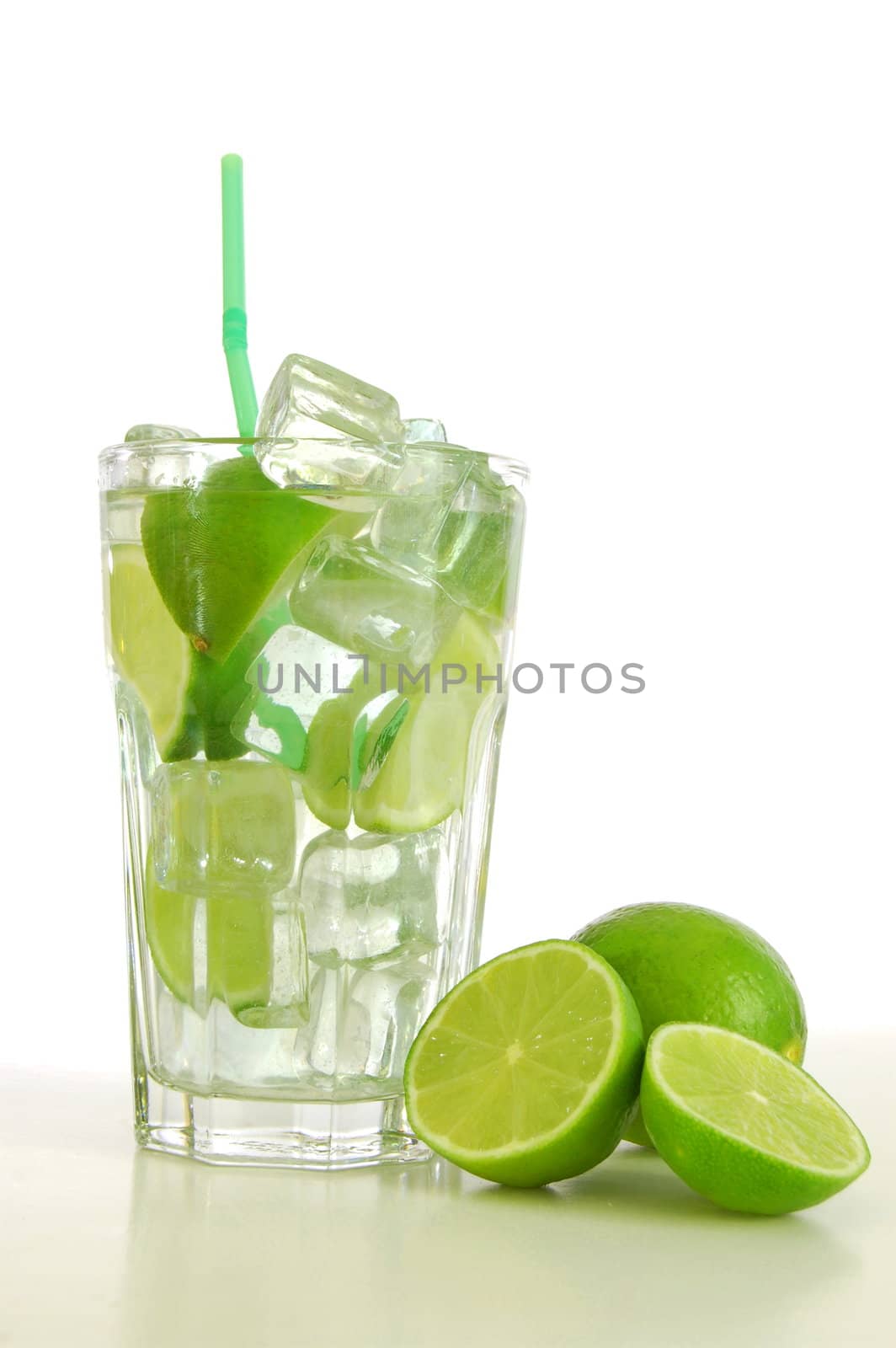 Caipirinha cocktail with green lemon and ice cubes