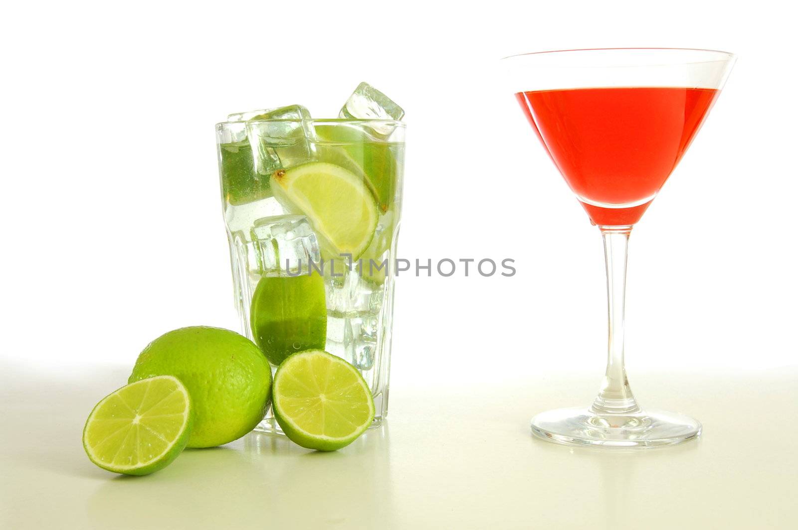 red and cold alcoholic drink with green lime