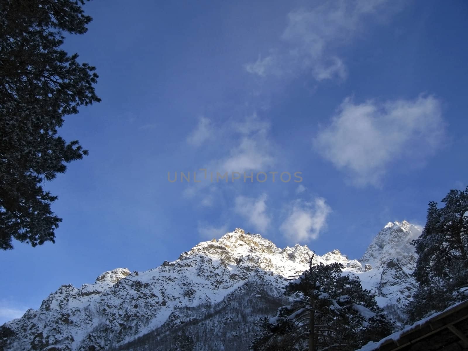 Mountain under the blue sky and the clouds
