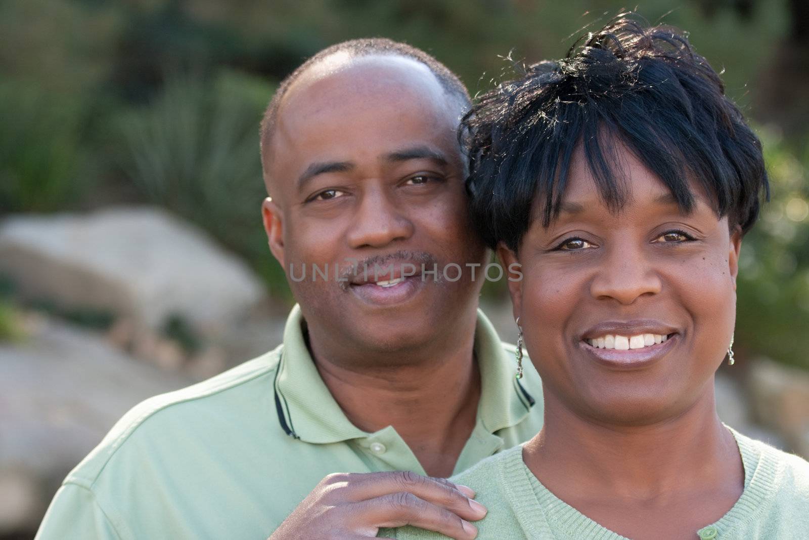 Attractive and Affectionate African American Couple posing in the park.